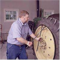 Image result for pictures of changing tractor tires