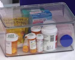 person packing their medicine cabinet