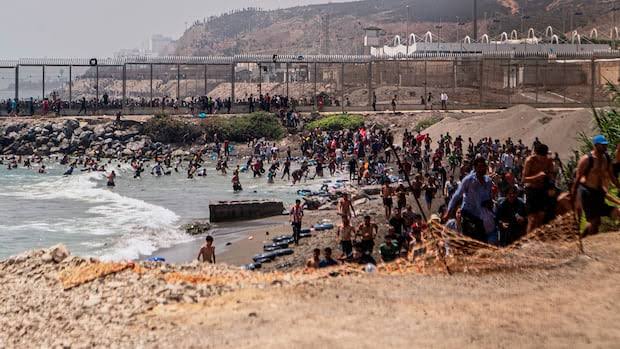 Spain deploys military to Ceuta after migrant surge; at least 57 migrants dead as thousands breached the border