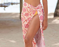 Image of woman wearing an Aline skirt with a camisole on a beach