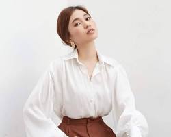 woman wearing a blouse with bishop sleeves
