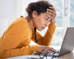 Image of person looking confused in front of a bank