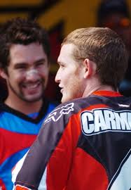 Ricky Carmichael says something that strikes his friend and fellow racer Ernesto Fonseca as funny prior to the start of the Binghamton National Motocross in ... - LWL_21581