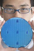 Man Holding Silicon Wafer. Corbis PhotosRF Royalty Free - 42-15530764