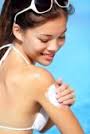sun tan lotion : Sunscreen woman putting sunblock lotion on shoulder before tanning during summer holiday &middot; Sunscreen woman putting sunblock.. #13281753 - 13281753-sunscreen-woman-putting-sunblock-lotion-on-shoulder-before-tanning-during-summer-holiday-on-beach-va