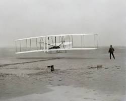 Image of Wright brothers and their 1903 Wright Flyer.