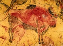 A bison depiction in the Altamira Cave, discovered in the north of Spain and dated between 35,000 and 15,000 BC, and a bison living in Europe today.