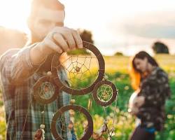 Image of person holding a dreamcatcher
