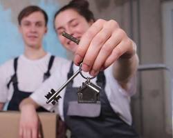 happy Canadian couple holding keys in front of a modern house mortgage preapproval concept, AI generated