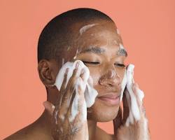 Image of person cleansing their face