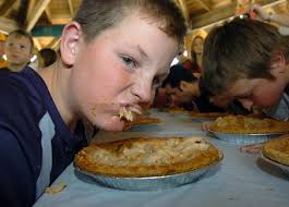 Lon Horwedel | The Ann Arbor NewsKyle DeVoogd, 12, sneers at competitor Trevor Omer, 14, as they woof down apple pies in the Dexter Lions Club Apple Pie ... - large_101108daze1