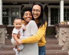 Image of diverse family smiling in front of a house