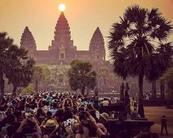 A peaceful sunrise over Angkor Wat, Cambodia, reflecting in the water.