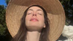 Anne Hathaway Almost Pops Out of Plunging Saint Laurent Striped Suit