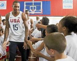 Image of Carmelo Anthony interacting with young athletes or children