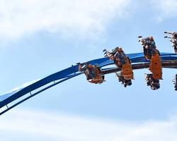 Image of rollercoaster soaring through the sky