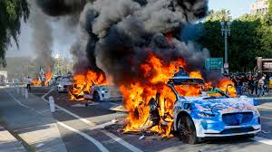 Photos show Waymo vehicles on fire during L.A. protests as company cuts service