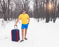 Image of people in shorts and flipflops standing in a small amount of snow