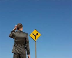 Image of confused person looking at a road sign