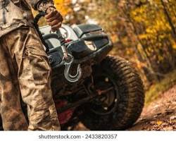 Image of offroad 4x4 vehicle equipped with recovery gear winch and snorkel on extreme muddy trail photo