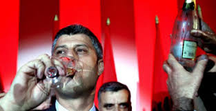The leader of the Democratic Party of Kosovo (PDK) Hashim Thaci drinks champagne after winning Kosovo&#39;s general elections in Pristina. - kosovo372x192