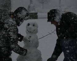 Image of person building a snowman in Texas