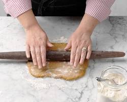 Image of Rolling out dough on a floured surface