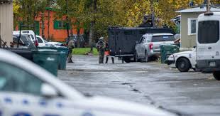 East Anchorage standoff suspect shot 2 people waiting to pick up children 
near school, charges say