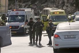 A military checkpoint near Hebron with soldiers present, illustrating the site of the shooting attack.