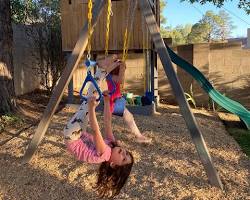 Image of happy child playing on a playground with fresh mulch