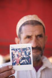 Abderrahim El Makkouri shows a photo of himself as a young storyteller. “The Last Storytellers succeeds brilliantly in delving down through the endless ... - RH-04