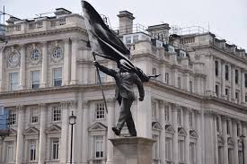 Attributed to Banksy, a New Statue of a Suited Man, Blinded by a Flag and Walking Off a Ledge, Appeared in Central London