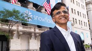 Snowflake CEO Ridhar Ramaswamy beside Snowflake signage