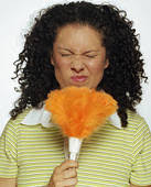 Woman holding feather duster up to face, twitching nose, eyes closed. Fotosearch Stock ImagesRF Royalty Free - x13521724