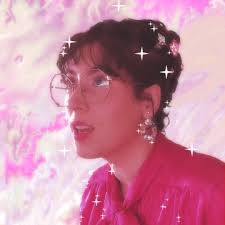 Terry from Cute Games Club, a brunette white woman in a pink buttoned shirt and thin-rimmed glasses