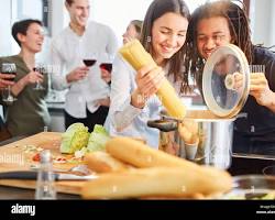 Image of someone happily cooking in a rented kitchen