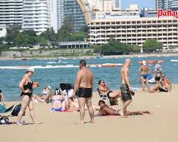 Image of Pattaya Beach with sunbathers and water sports