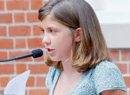 Douglass Essay Contest Winner Juliette Neil reads her award-winner essay for the people during the &quot;Douglass Returns&quot; memorial unveiling ceremony on ... - 4dfdeaaa646ca.image