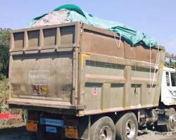 Image of Covered truck transporting waste