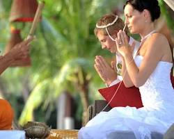 Image of Thai monks chanting blessings for a couple at a wedding ceremony in Thailand