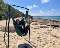 person relaxing on a hammock on an Okinawa beachの画像