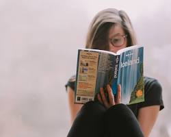 person reading a travel guide