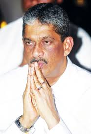 General Sarath Fonseka (Retd) in a reflective mood as he paid obeisance at the Kelaniya Raja Maha Viharaya hours after having tendered his letter of ... - Sarath-Fonseka