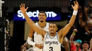 Victor Wembanyama with a shaved head showcasing his new style