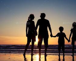 Family Standing on Beachの画像