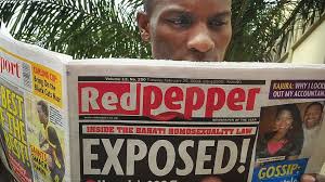 Uganda-red-pepper-newspaper A Ugandan reads a copy of the &quot;Red Pepper&quot; tabloid newspaper in Kampala, Uganda on Feb. 25, 2014. - uganda-red-pepper-newspaper