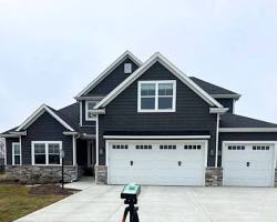 Image of home inspection meticulously examining a home's roof