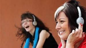 Getting loud in the library: student Elizabeth Durbidge and Mount Gambier Library&#39;s Terasa Nearmy test out the &#39;silent disco&#39; equipment. - r1259675_16860496