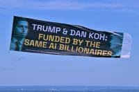 Aerial Banner References Dan Koh and AI Backers Ahead of MA-06 Primary