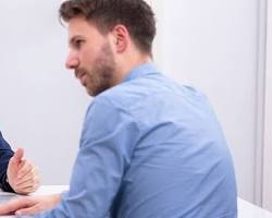 Image of couple sitting down with a mediator